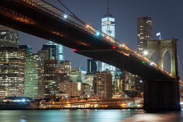 Fototapeta na wymiar Lower Manhattan with Brooklyn bridge from across the Hudson river at night
