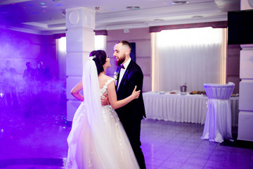 Beautiful dance of a young couple in the dance floor