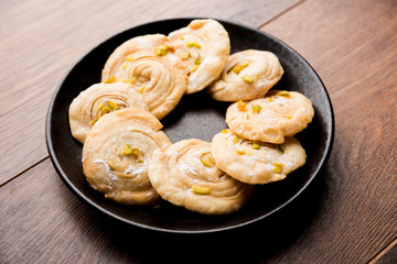 Obraz na płótnie Canvas Chirote or Chiroti is a sweet dish from Karnataka and Maharashtra. Served in a plate as a dessert on Festivals or wedding. Selective focus
