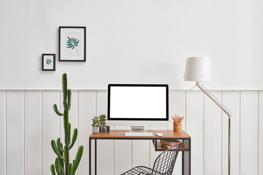 Modern working room. white wall frame and cactus white lamp.