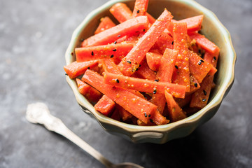 Carrot Pickle / Gajar ka Achar or Loncha in hindi. Served in a bowl over moody background....