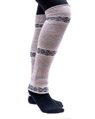 Young woman wearing lemon Fair Isle leg warmers isolated on white background