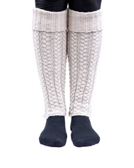 Young woman wearing cable knit leg warmers ivory color isolated on white background