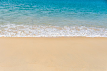 Fototapeta na wymiar beautiful soft wave on sand at the sea sunny day. subject is blurred.