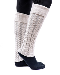 Young woman wearing cable knit leg warmers ivory color isolated on white background