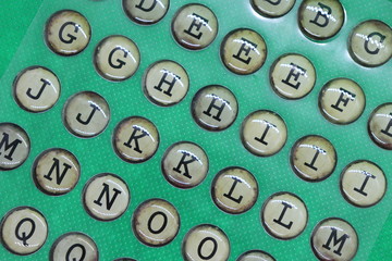 Letters on round circles against green background