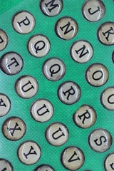 Retro letters in circles like typewriter keys on green background