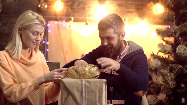 Couple preparing New Year party. Presents under the Christmas tree. Merry christmas and Happy new year. Couple celebrating in New Year party.
