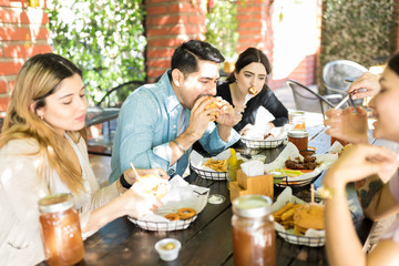 Men And Women Having Midday Meal At Burger Shop