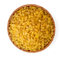 Bulgur porridge in a wooden plate top view.