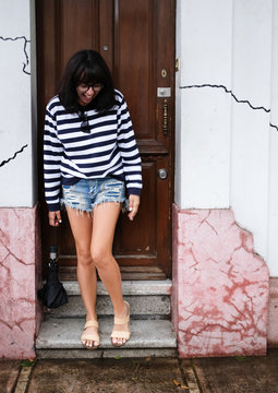 Woman Exiting House