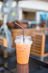 ice Thai tea on table. soft focus.