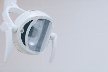 Dental light close up in dentist office. Dental clinic equipment - close up image of medical exam light. White tone.