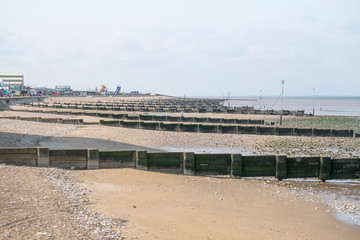 Fototapeta na wymiar Wooden groynes on the beach at Hunstanton, Norfolk, UK