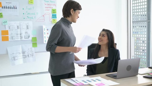 Asian managers talking achievement task to employee female. Businesswoman happy and smiling. concept of business management success, good job and achievement.