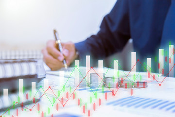 Close up,Hand putting money coins stack in saving money and growing business concept.