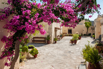 Fototapeta na wymiar courtyard of monastery with pink blossomed tree