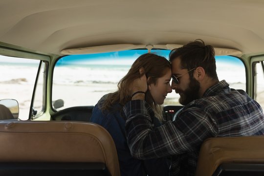 Couple embracing in vehicle on roadtrip
