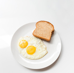 Fototapeta premium Breakfast dish of eggs and bread slice.