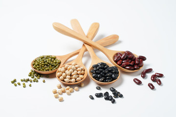 Many nuts and sesame seeds on white background.