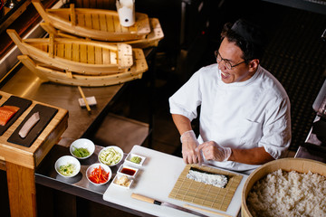chef laughing at something while working in the kitchen. close up photo. happiness, fun, good mood in the kitchen