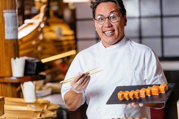 excited emotional man is happy as he has prepared fantastic yummy roll. close up photo