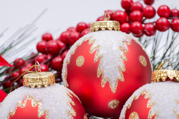 Blooming Holiday Red Poinsettia, Pine and Berry bush and ornament decoration in the form of...