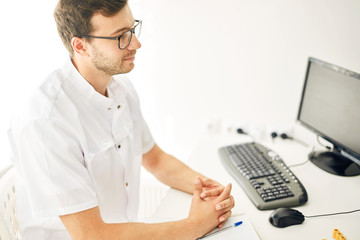 attractive tired therapist is listening to the client's complaints. close up side view photo. working day in the clinic