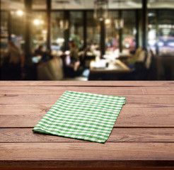Tablecloth on wooden table and cafe blurred background