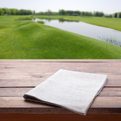 Wooden deck table with towel over summer background. Kitchen background, product montage display. Mock up .