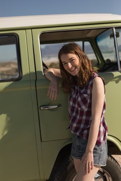 Woman leaning on van