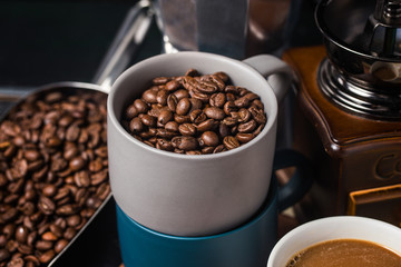 Coffee cup and beans on old kitchen table.