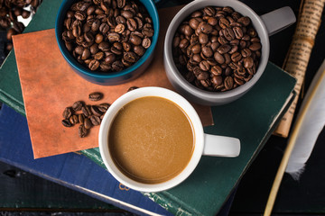 Coffee cup and beans on old kitchen table.