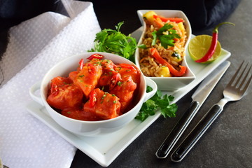 Chicken stew with pineapple and chili tomato sauce in a white bowl