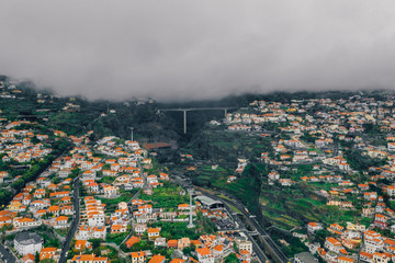 Aerial view of the Funchal old town - the capital of Madeira island during cloudy weather. Small...