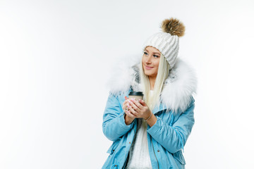 Obraz premium Fashion studio portrait of beautiful lady in blue fur coat and fur hat. Winter beauty in luxury. Fashion fur. Beautiful woman in luxury fur coat. Fashion model posing in eco-fur coat and eco-fur hat