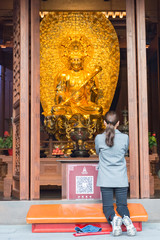 Shanghai. Woman praying in jade Buddha Temple