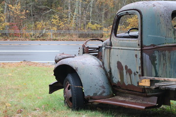 Old rusty antique truck on roadside