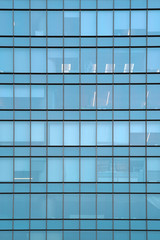 Glass blue square Windows of facade modern city business building skyscraper. Modern apartment...