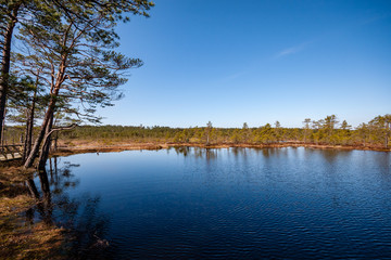 colorful sunset on the lake with water reflections and dramatic storm clouds above