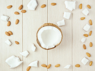Composition with coconut and almonds on the wood. - 233784945
