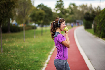 Fitness woman eating apple