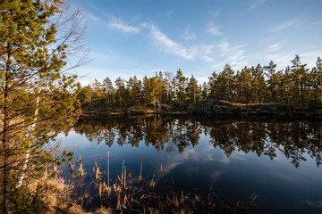 colorful sunset on the lake with water reflections and dramatic storm clouds above