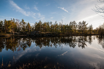 Fototapeta premium colorful sunset on the lake with water reflections and dramatic storm clouds above