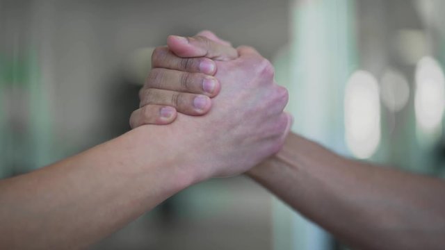 Hands of men high five closeup Two hands takes each other in friendly way