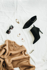Flat lay, top view fashion concept. Trendy woman clothes and accessories on white blanket. - obrazy, fototapety, plakaty