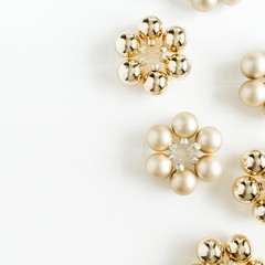 Christmas composition with golden decoration balls on white background. Flat lay, top view. Blog hero header.