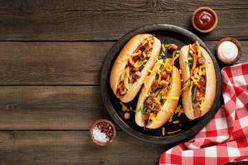 Homemade Hot Chili Dog with Cheddar Cheese and grilled vegetables