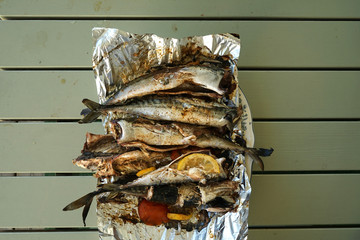 Fresh, raw mackerel with spices are on the table.