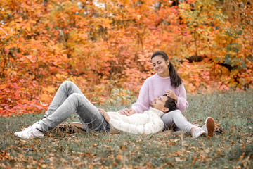 Couple in love in the autumn leaves